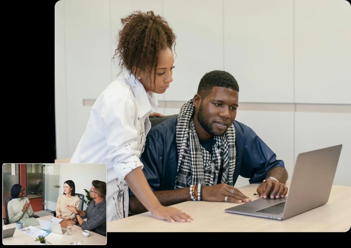 A man and woman working on a laptop